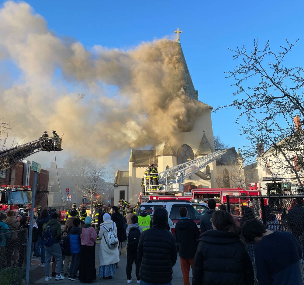 Smoke plumes rise from the Faith Lutheran Church, which caught fire, in Cambridge, April 9. (Dan Mauzy/WBUR)