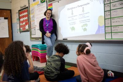 Juliana Santos listens to a student in her classroom at Potter Road Elementary School in Framingham. (Robin Lubbock/WBUR)