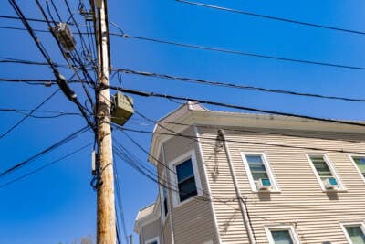 Power lines running to an apartment building in Somerville. (Jesse Costa/WBUR)