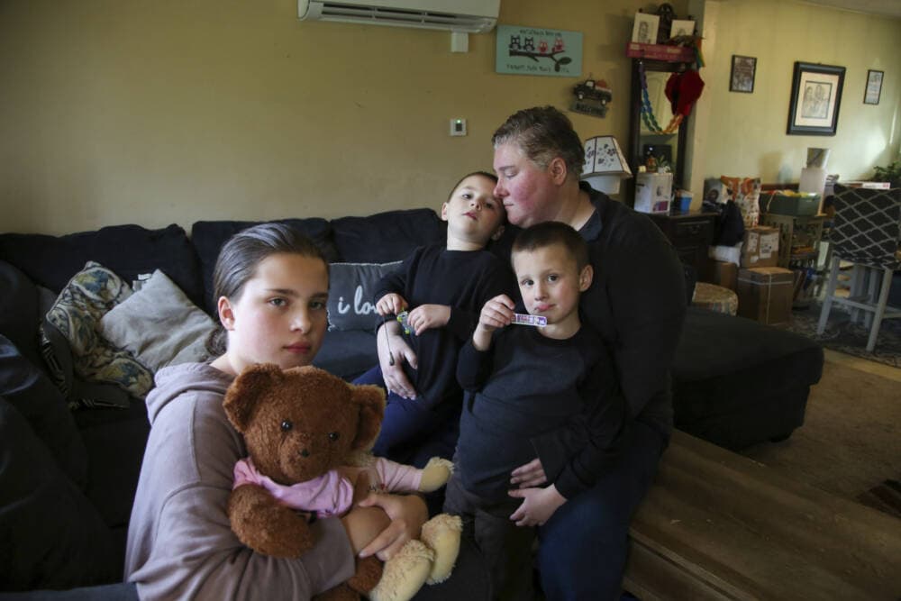 Jillian Philips sits with her children Macy, 10, and 4-year old twins, Emmett and Jude, right, in their home, Tuesday, May 2, 2023, in North Brookfield, Mass. (Reba Saldanha/AP)