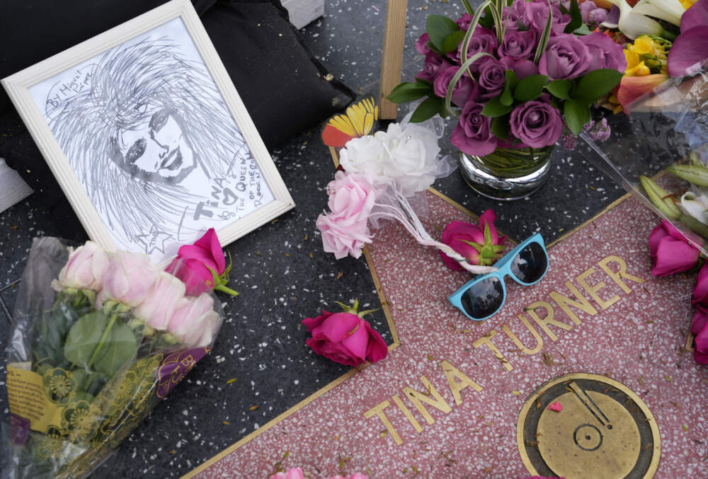 A portrait of the late singer Tina Turner sits next to flowers at her star on the Hollywood Walk of Fame. (Chris Pizzello/AP)