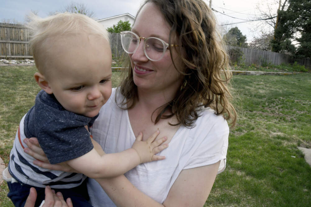 Sarah Perkins holds her 1-year-old son, Cal Sabey, at a relative's home in Centennial, Colo., Wednesday, May 3, 2023. (Thomas Peipert/AP)