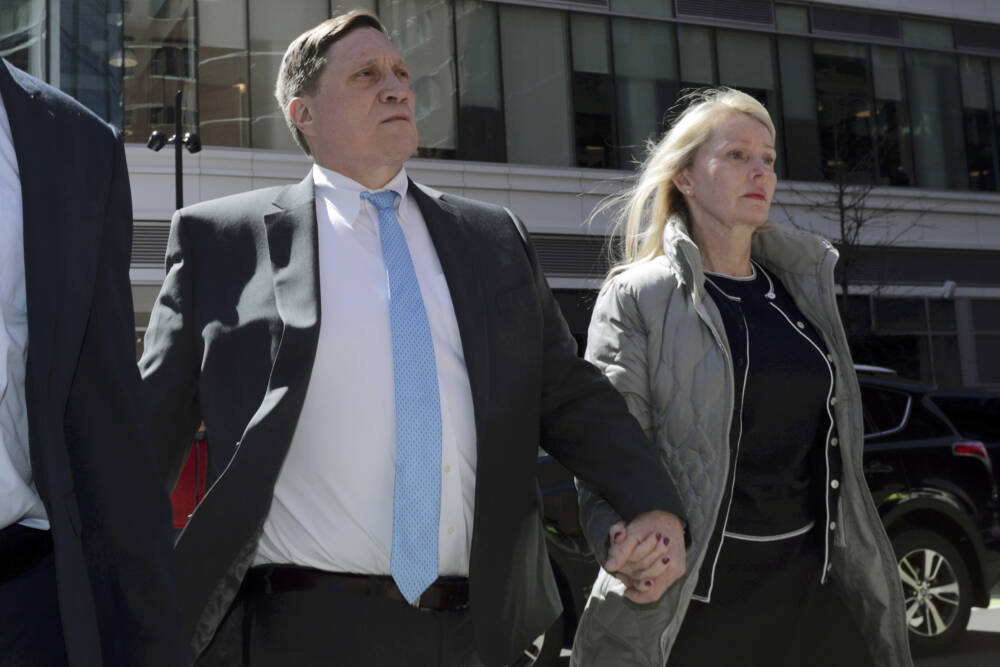 John Wilson, of Lynn, arrives at federal court with his wife Leslie, April 3, 2019, to face charges in a nationwide college admissions bribery scandal, in Boston.  (Charles Krupa/AP)
