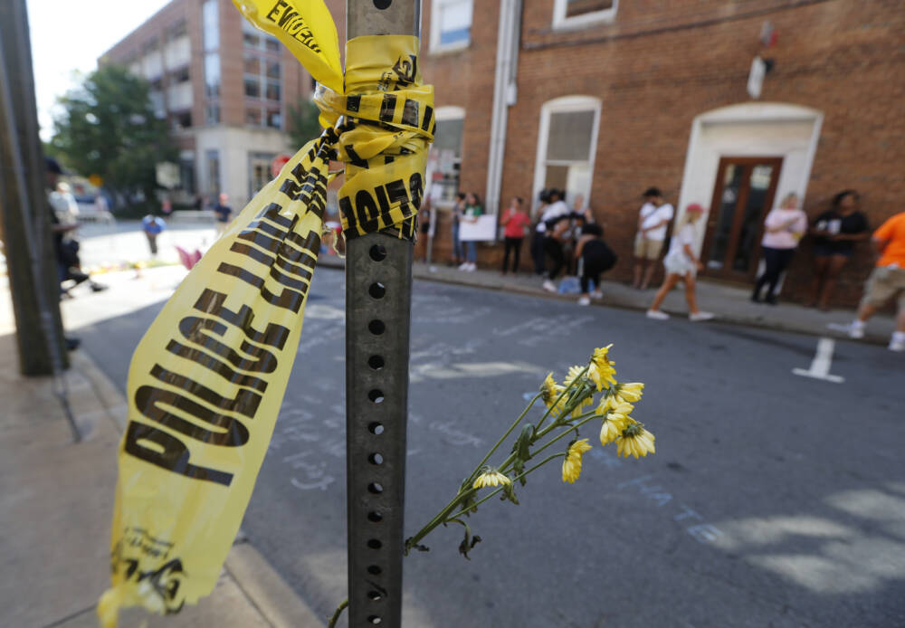 On Sunday, Aug. 13, 2017, police tape and flowers mark the site where a car plowed into a crowd of people protesting a white nationalist rally on Saturday in Charlottesville, Va. (Steve Helber/AP)