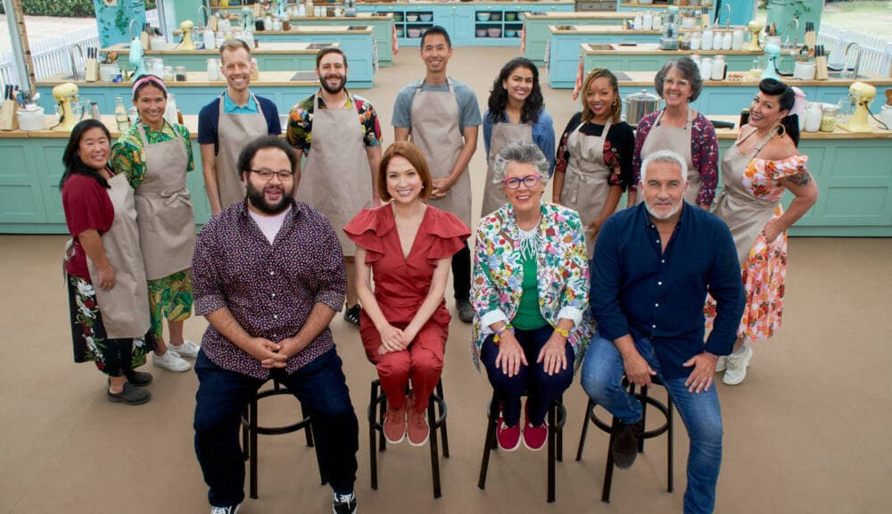 (Front row, L-R) Zach Cherry, Ellie Kemper, Prue Leith and Paul Hollywood sit with the contestants on &quot;The Great American Baking Show.&quot; (Courtesy of &quot;The Great American Baking Show&quot;)
