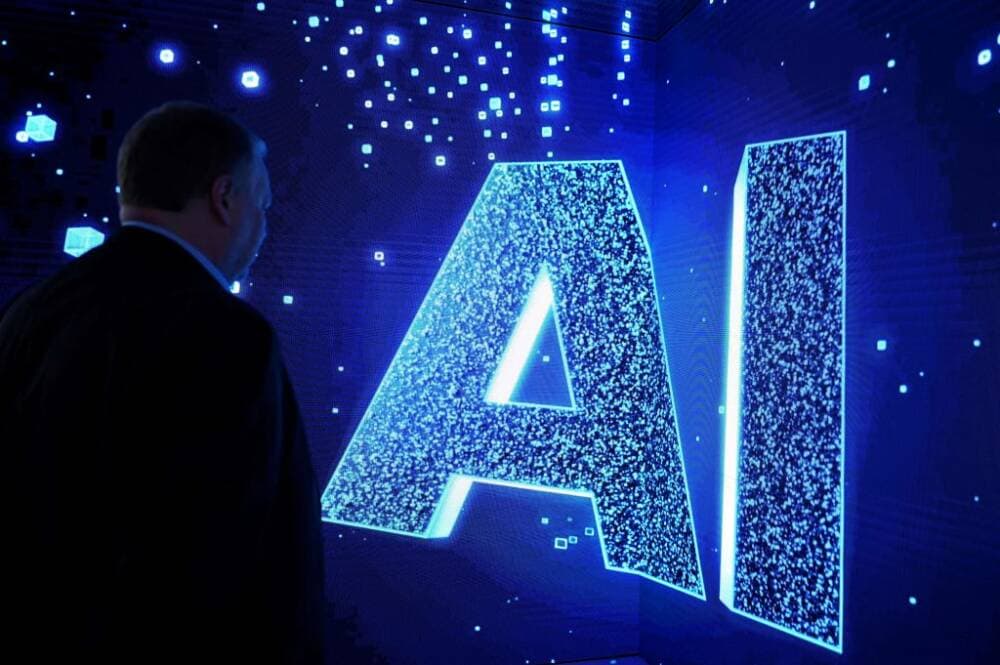 A visitor watches an AI (Artificial Intelligence) sign on an animated screen at the Mobile World Congress (MWC), the telecom industry's biggest annual gathering, in Barcelona. (Photo by Josep LAGO / AFP) (Photo by JOSEP LAGO/AFP via Getty Images)