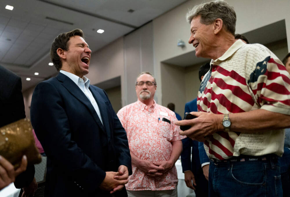Florida Gov. Ron DeSantis (L) speaks with attendees during an Iowa GOP reception on May 13, 2023 in Cedar Rapids, Iowa. (Photo by Stephen Maturen/Getty Images)