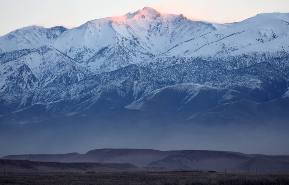The snow-covered eastern edge of the Sierra Nevada mountain range is viewed shortly after sunrise after a series of atmospheric river storms brought heavy snowfall to the mountain range on Jan. 22, 2023 in Bishop, California. (Mario Tama/Getty Images)