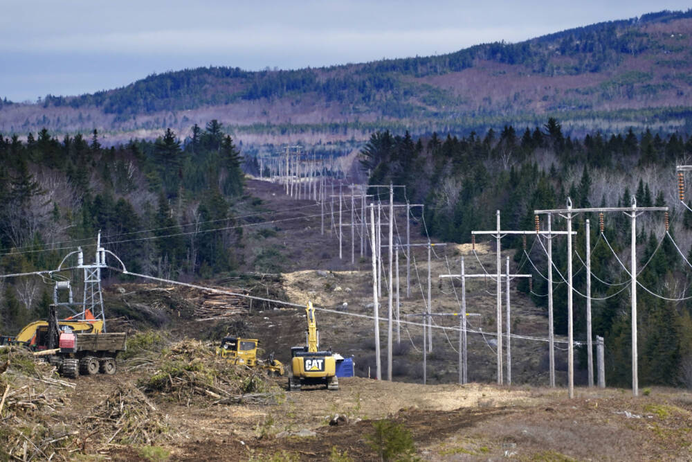 Heavy machinery is used to cut trees to widen an existing Central Maine Power power line corridor to make way for new utility poles, April 26, 2021, near Bingham, Maine. Attorneys will deliver opening statements Monday, April 10, 2023, in a trial that'll determine whether whether a $1 billion electric transmission corridor is built. The power line would bring Canadian hydropower to the New England grid. (Robert F. Bukaty/AP)