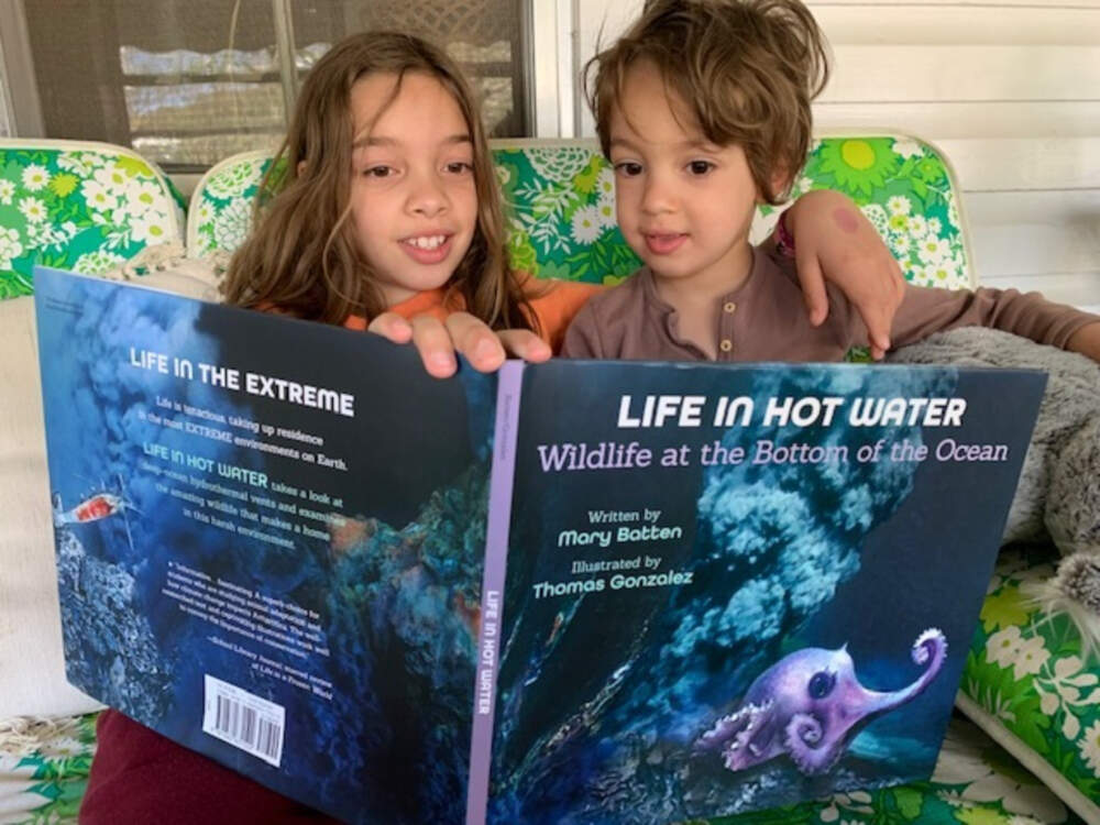 Author Mary Batten's 10-year-old granddaughter reading her latest book, Life in Hot Water: Wildlife at the Bottom of the Ocean, to her 4-year-old brother. (Courtesy of Mary Batten)