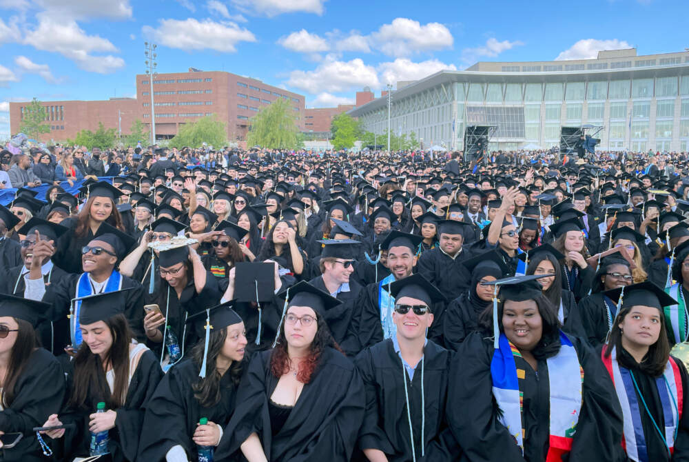 Hundreds of graduates gathered outdoors during UMass Boston's commencement ceremony on Columbia Point.