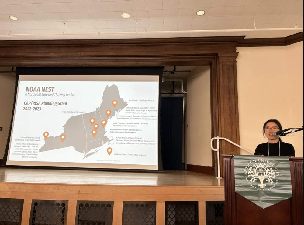 Cornell professor Linda Shi talks to an audience in Kenne about climate migration on May 17, 2023. (Mara Hoplamazian/NHPR)