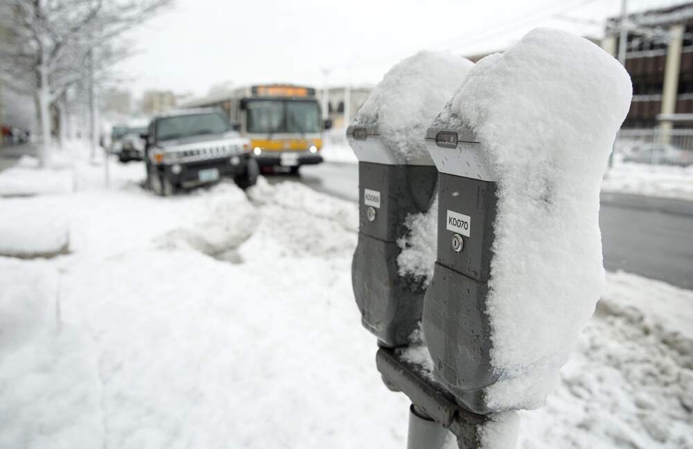 Wet overnight snow sticks to parking meters in Boston. (Robin Lubbock/WBUR)