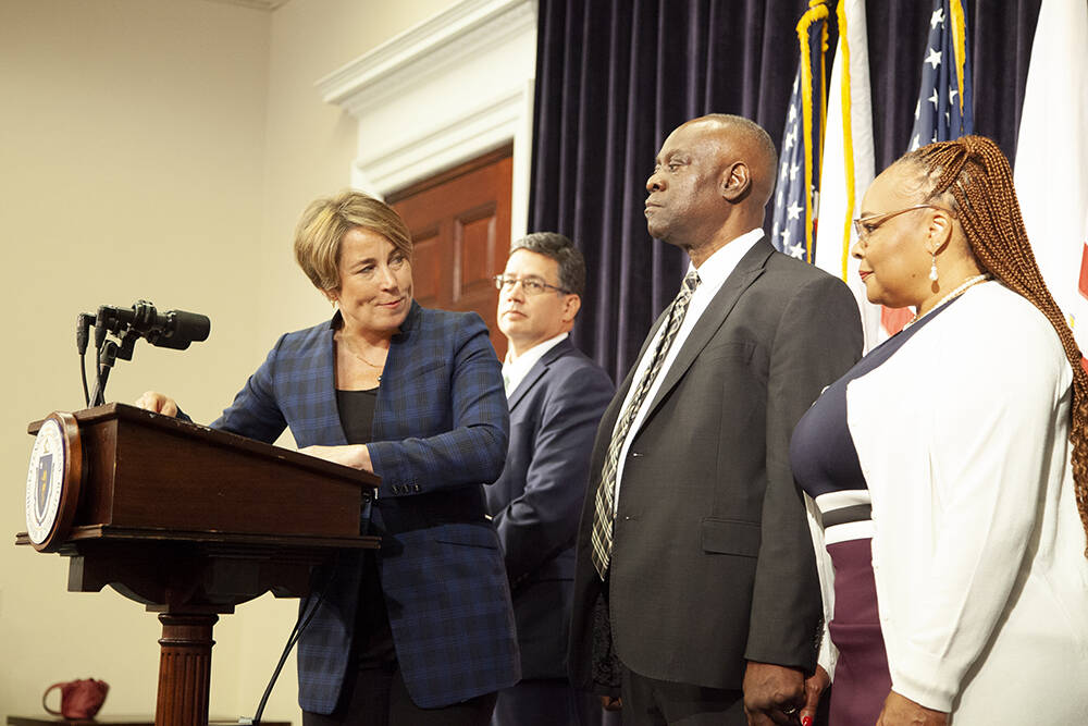 Gov. Maura Healey moved to pardon Glendon King (second from right) and six other individuals on a range of convictions that range in age from 17 years old to 57 years old. (Chris Lisinski/SHNS)