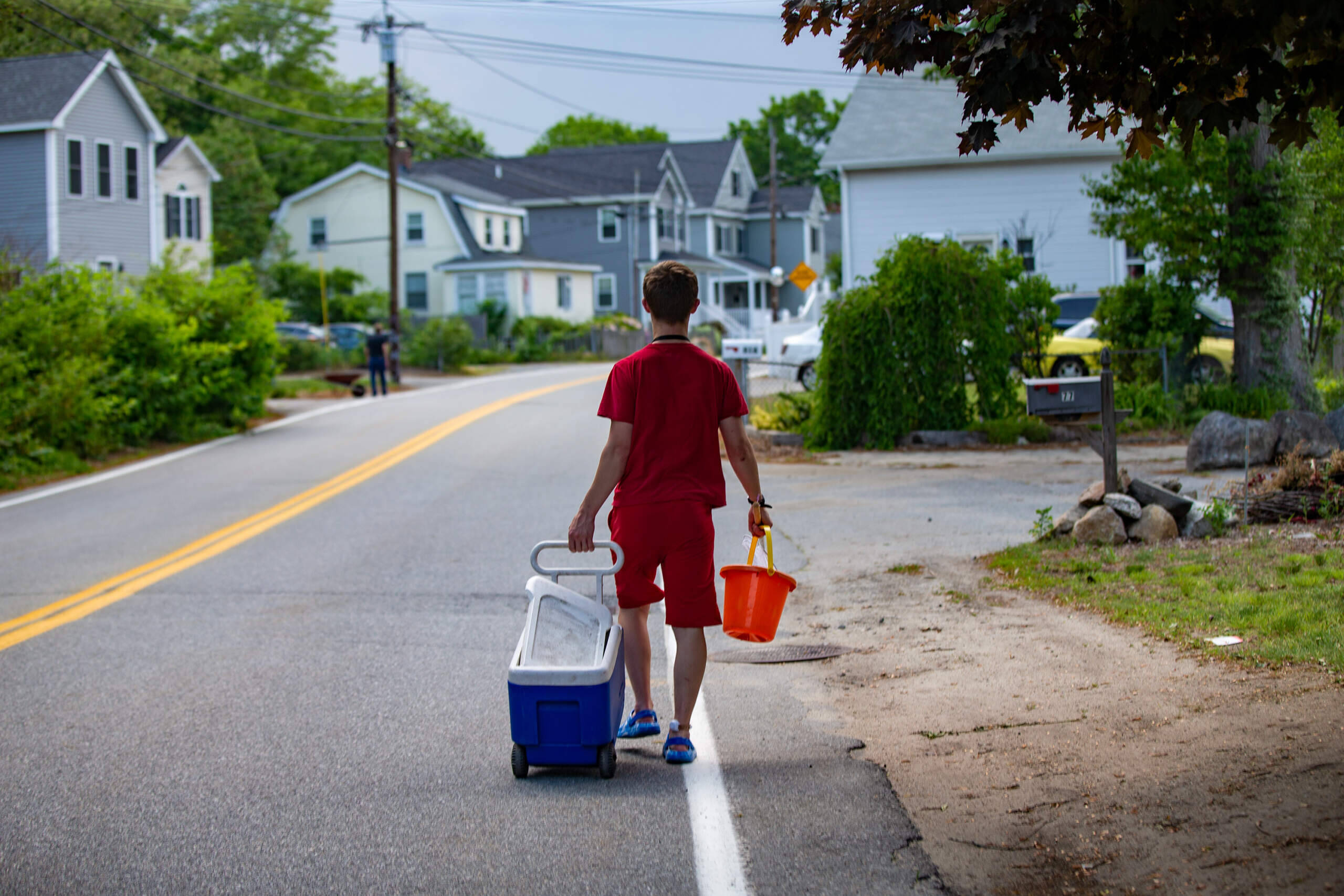 Connor Biscan walks very fast to get home to beat a thunderstorm that was entering the area after fishing at Silver Lake. (Jesse Costa/WBUR)