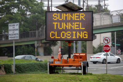 Signs near the Sumner Tunnel entrance warn drivers of tunnel closures this summer. (Robin Lubbock/WBUR)