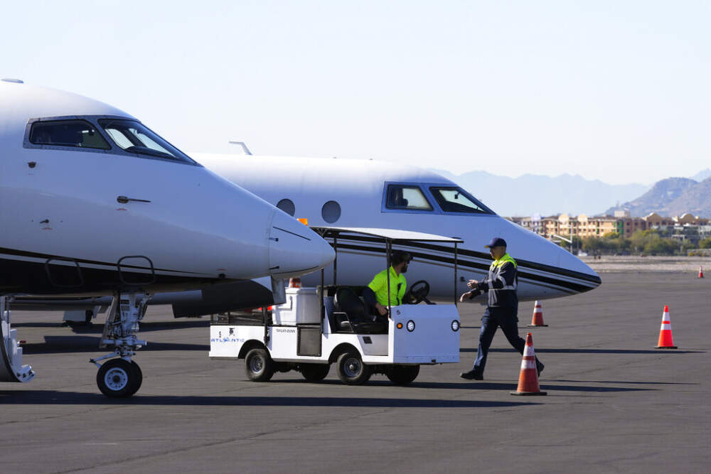 Scottsdale Airport staff prep a private jet, gearing up for the expected dramatic increase in private jet traffic before the NFL Super Bowl LVII football game at Scottsdale Airport in Scottsdale, Ariz., Feb. 2, 2023. (Ross D. Franklin/AP)