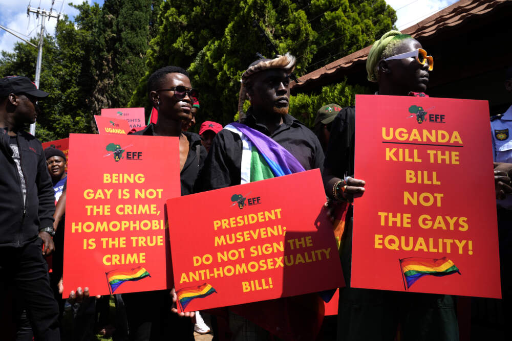 Activists hold placards during their picket against Uganda's anti-homosexuality bill. (Themba Hadebe/AP)