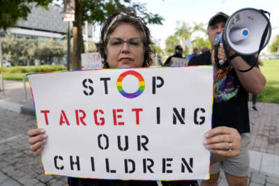 A person who gave her name as Marlene holds a sign as she protests outside of a Target store, Thursday, June 1, 2023, in Miami. Target announced last week that it removed products and relocated Pride displays to the back of certain stores in the South. Activists in the LGBTQ+ community are calling for new campaigns to convince corporate leaders not to cave to anti-LGBTQ+ groups. (Lynne Sladky/AP)