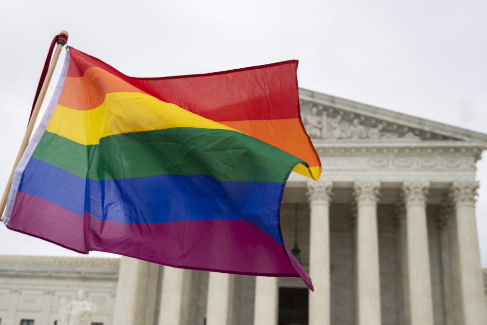 Supporters wave a pride flag in front of the U.S. Supreme Court, Oct. 8, 2019, in Washington. (Manuel Balce Ceneta/AP)
