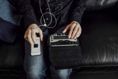 Man using Braille keyboard and smart phone. (Getty/Johner Images)
