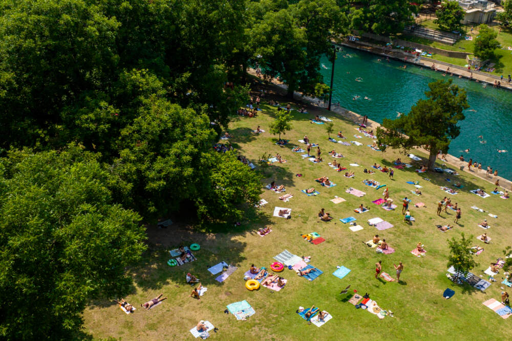 People gather at Barton Springs Pool on June 21, 2023 in Austin, Texas. Extreme temperatures across the state have prompted the National Weather Service to issue excessive heat warnings and heat advisories that affect more than 40 million people. (Brandon Bell/Getty Images)