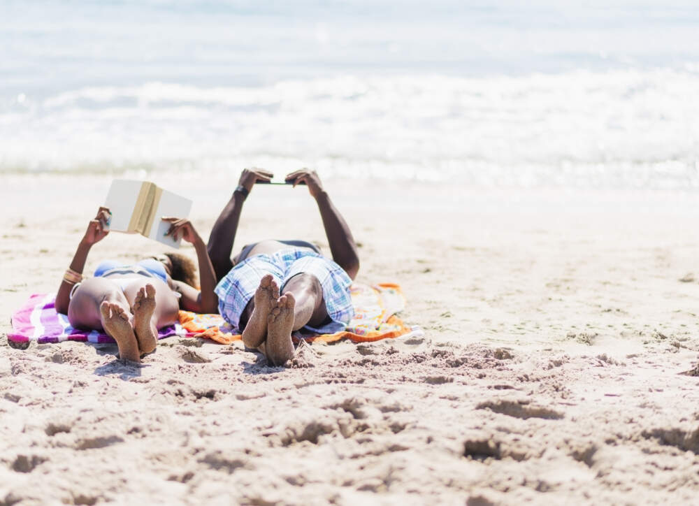A couple reading on the beach. (Getty Images)