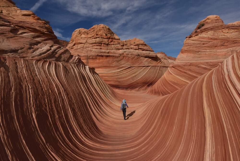 Hikers walk amongst the unique U-shaped troughs of 'The Wave' rock formation at the Coyotes Buttes North wilderness area near Page, Arizona. (Mark Ralston/AFP via Getty Images)