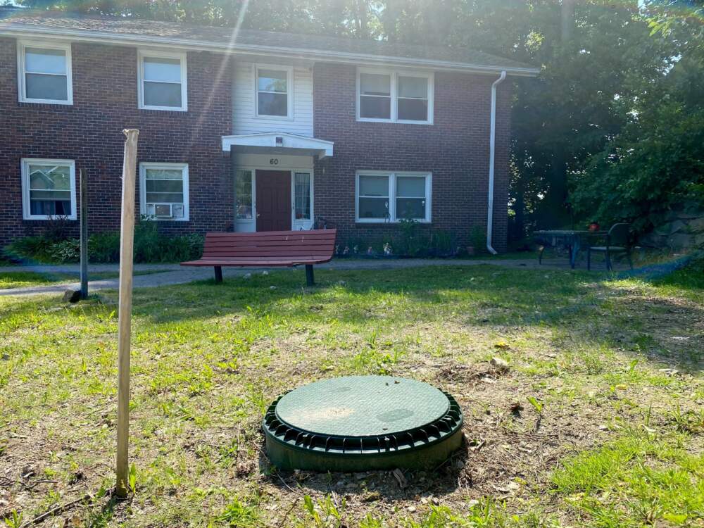 A cover above one of the three test holes Eversource has dug for a geothermal pilot project that will heat and cool 37 buildings in Framingham. (Miriam Wasser/WBUR)