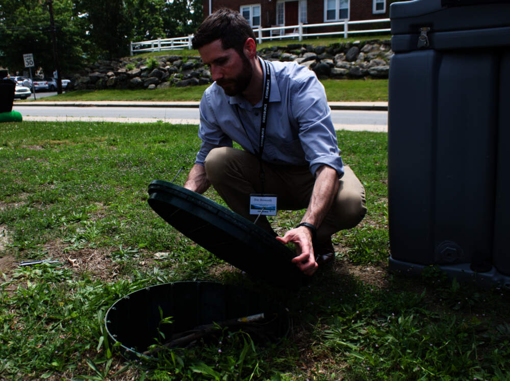 Eric Bosworth of Eversource opens one of the test boreholes for the networked geothermal system in Framingham. (Miriam Wasser/WBUR)