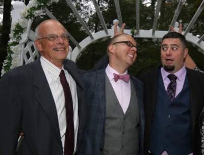 The author (center) with his father-in-law, Dave Sirois Sr. (left), and his husband, Dave Sirois Jr. (right), at his wedding reception in Massachusetts in 2016. (Courtesy Jason Prokowiew)