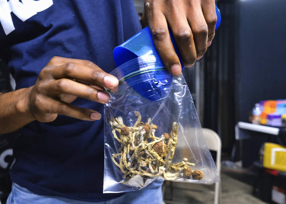 A vendor bags psilocybin mushrooms at a cannabis marketplace on May 24, 2019, in Los Angeles. (Richard Vogel/AP)