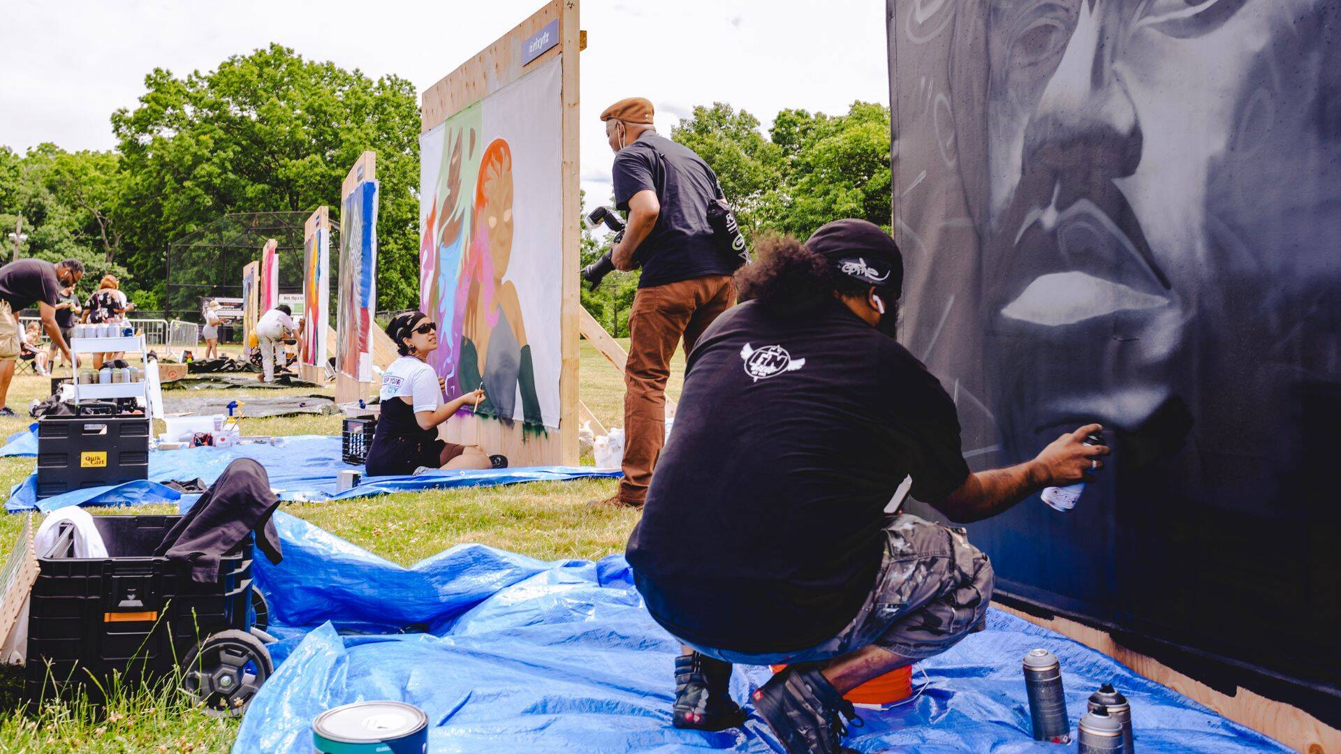Artists work on their canvases at the 2022 BAMS Fest.