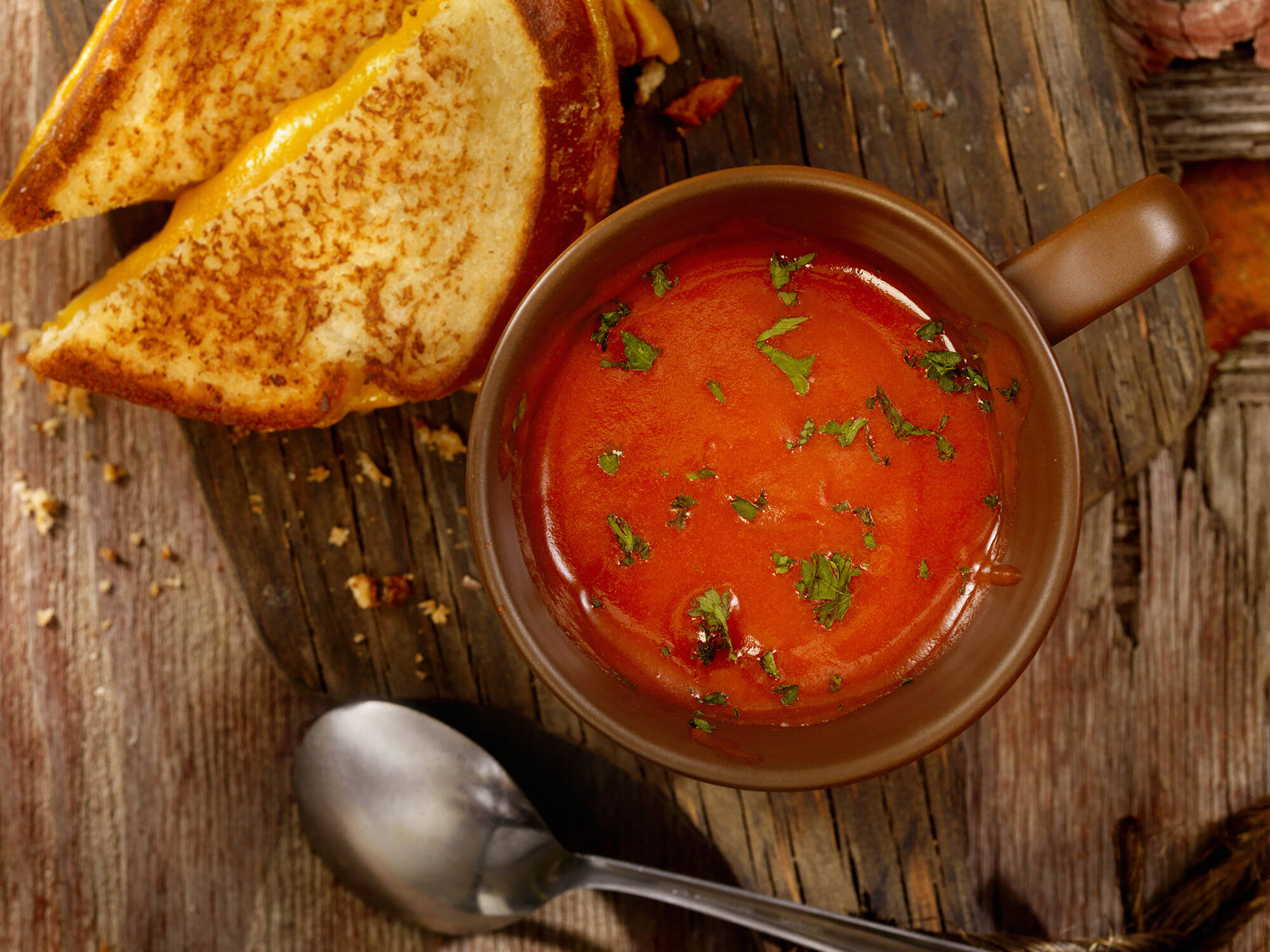 Tomato soup with a grilled cheese sandwich. (LauriPatterson via Getty Images)