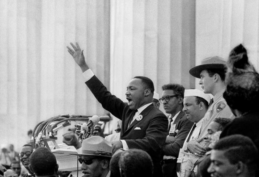 As King delivers his “I Have a Dream” speech, Bayard Rustin (in glasses) stands behind,
Gordon “Gunny” Gundrum (park ranger) eyes the crowd, and Mahalia Jackson (hat and
back of head visible) stands and shouts.
(© Bob Adelman