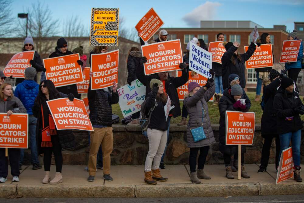 Woburn teachers strike in front of Woburn Memorial High School on January 30, 2023. (Jesse Costa/WBUR)