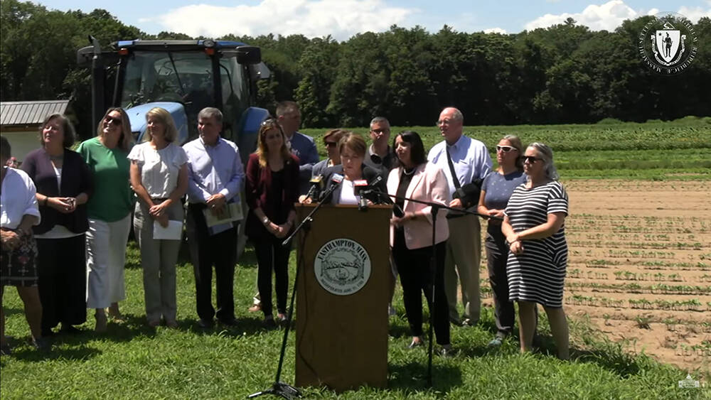 Gov. Maura Healey speaks from a podium her office set up at Mountain View Farm in Easthampton, where she urged Bay Staters to donate to a new &quot;Farm Resiliency Fund&quot; to support those recovering from floods that damaged crops. (Screenshot)