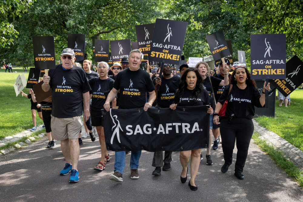 Striking SAG-AFTRA union members march across Boston Common. (Robin Lubbock/WBUR)