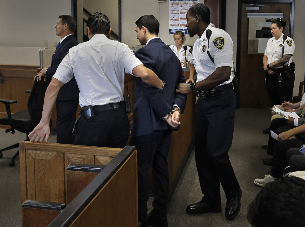 Matthew Nilo, in handcuffs, is escorted by court officers during an appearance at Suffolk Superior Court, Thursday, July 13, 2023, in Boston. (Lane Turner/The Boston Globe via AP, Pool)