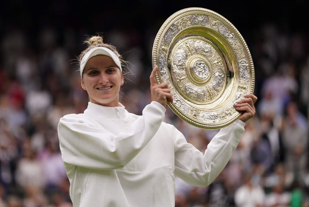 Czech Republic's Marketa Vondrousova celebrates with the trophy after beating Tunisia's Ons Jabeur to win the final of the women's singles on day thirteen of the Wimbledon tennis championships. (Alberto Pezzali/AP)