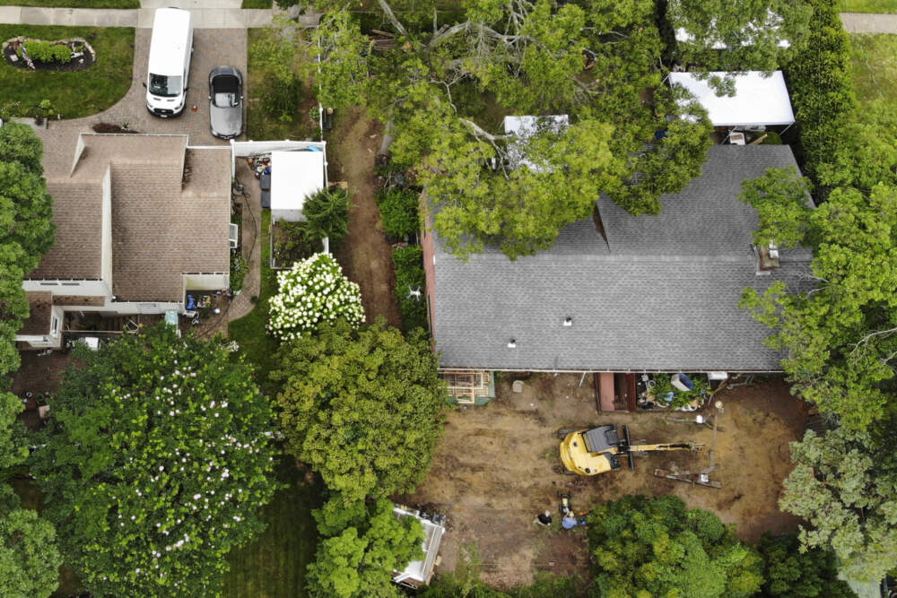 Authorities continue to work at the home of suspect Rex Heuermann, bottom right, in Massapequa Park, N.Y., Monday, July 24, 2023. Heuermann has been charged with killing at least three women in the long-unsolved slayings known as the Gilgo Beach killings. (Seth Wenig/AP)