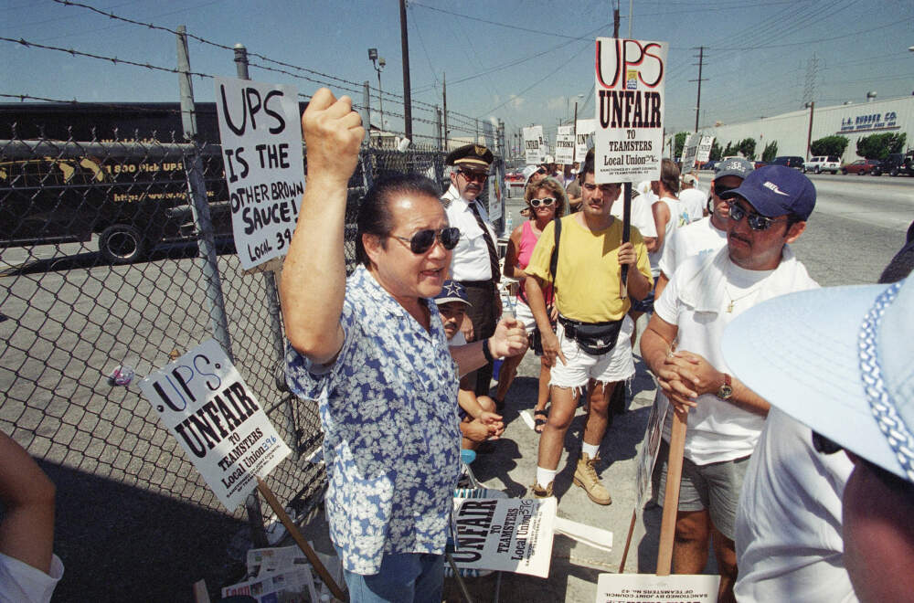 Bobby Kikuchi, president of Teamsters Local 396, talks to striking United Parcel Service workers on a picket line at a UPS distribution facility east of downtown Los Angeles in the third day of their strike on Wednesday, Aug. 6, 1997. (Reed Saxon/AP)