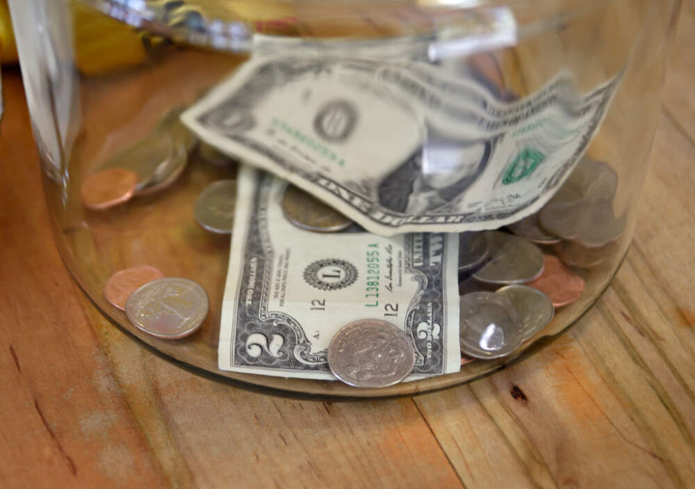 Money in a tip jar in a Taos, New Mexico, coffee shop includes a two dollar bill. (Photo by Robert Alexander/Getty Images)