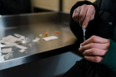 A woman uses the narcotic consumption booths at a safe injection site at OnPoint NYC in 2022. (Kent Nishimura / Los Angeles Times via Getty Images)
