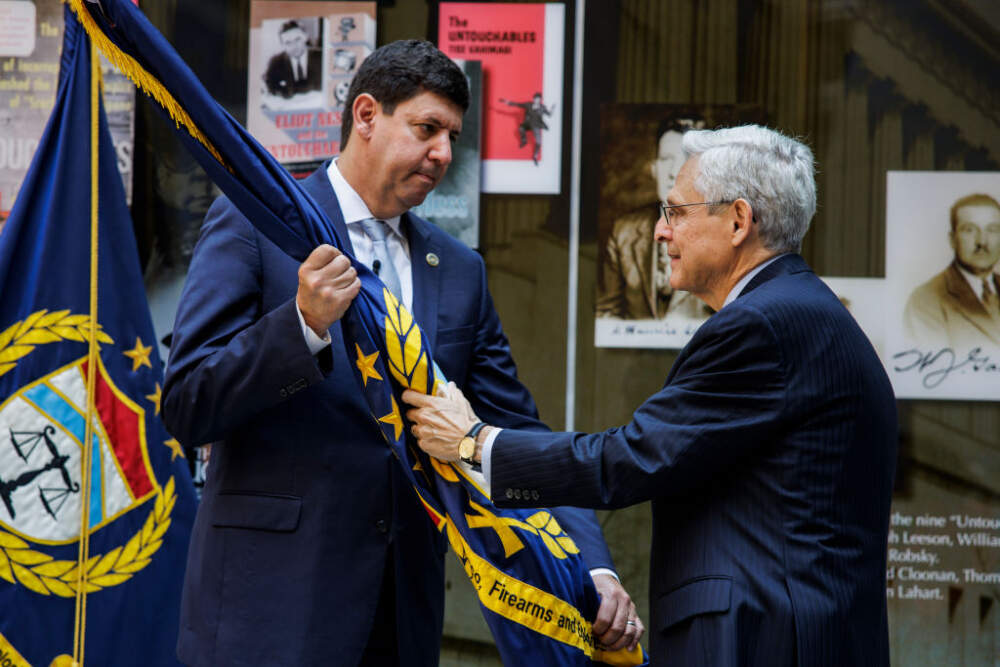 WASHINGTON, DC - JULY 19:  US Attorney General Merrick Garland (R) passed the flag to Steven Dettelbach (L) after swearing him in as the second person to be confirmed by Congress as the Director of The Bureau of Alcohol, Tobacco, Firearms, and Explosives (ATF) at the ATF headquarters on July 19, 2022 in Washington, DC. (Photo by Samuel Corum/Getty Images)