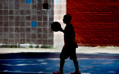 A basketball player shoots hoops on a hot day at the O'Day Playground in Boston's South End neighborhood. (Jonathan Wiggs/The Boston Globe via Getty Images)