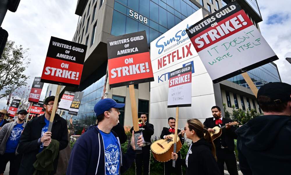 Writers on strike march with signs on the picket line on day four of the strike by the Writers Guild of America in front of Netflix in Hollywood, California on May 5, 2023. (Frederic J. Brown/AFP via Getty Images)