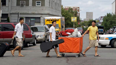 At Boston University, students — from left, Teddy Lo, John Lee and Roy Lee — move in on Aug. 30, 2008. (Mark Garfinkel/MediaNews Group/Boston Herald via Getty Images)