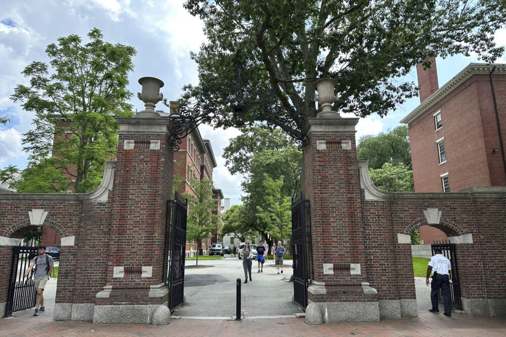 Students walk through a gate at Harvard University. (Michael Casey/AP Photo)