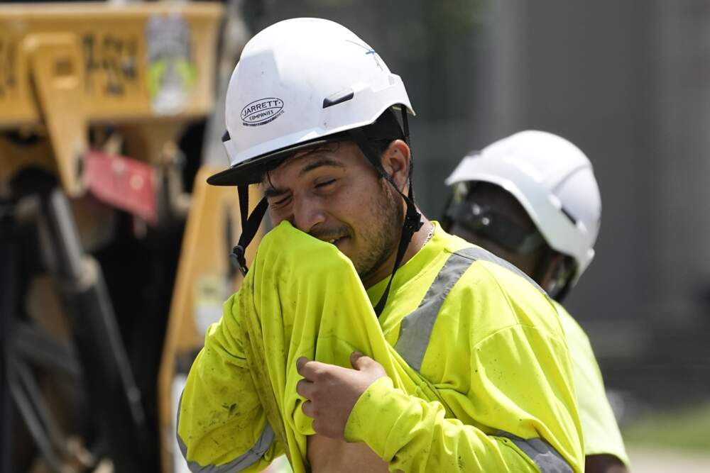 A construction worker wipes his face as he works in the heat last month in Nashville. (AP Photo/George Walker IV, File)